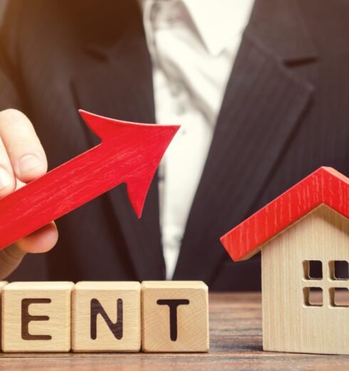 Wooden blocks with the word Rent, house and up arrow. The concept of the high cost of rent for an apartment or home. Interest rates are rising. Real estate market. Increased demand for rental property Wooden blocks with the word Rent, house and up arrow. The concept of the high cost of rent for an apartment or home. Interest rates are rising. Real estate market. Increased demand for rental property