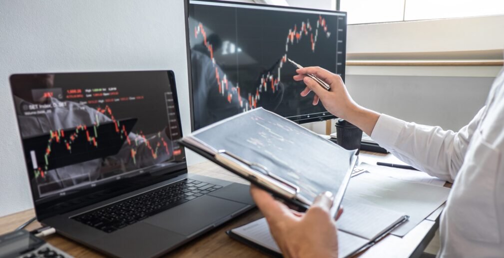 Stock exchange market concept, Business investor trading or stoc Stock exchange market concept, Business investor trading or stock brokers having a planning and analyzing with display screen and pointing on the data presented and deal on a stock exchange.