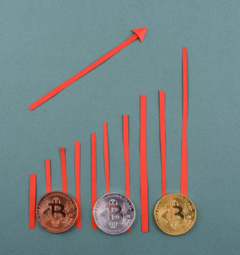 Bitcoin coins. Cryptocurrency growth and fall schedule Bitcoin coins on desk. Cryptocurrency growth and fall schedule