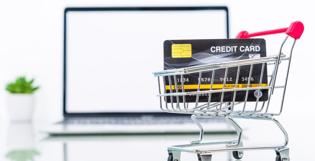 Credit card front of laptop screen with hand sanitizer and surgi Credit card front of laptop screen with hand sanitizer and surgical mask online shopping, Quarantine work from home concept against covid-19 epidemic