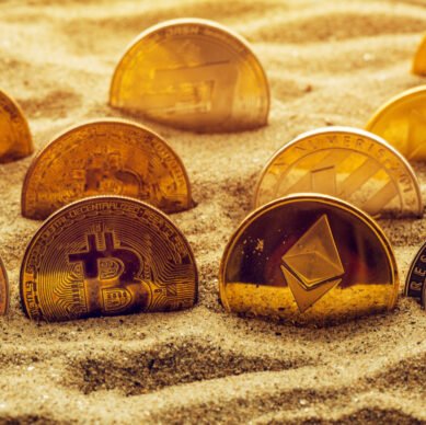 Cryptocurrency coins in sand, conceptual image for lost and found valuables that are standing the test of time.