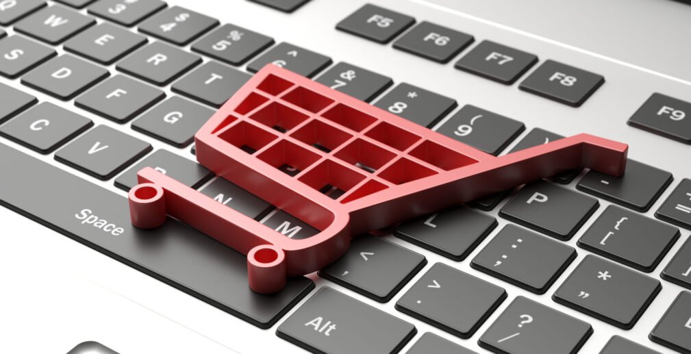 e-commerce symbol on a computer keyboard, black friday concept. 3d illustration E shop, e commerce concept. Shopping cart trolley icon on a computer laptop. 3d illustration