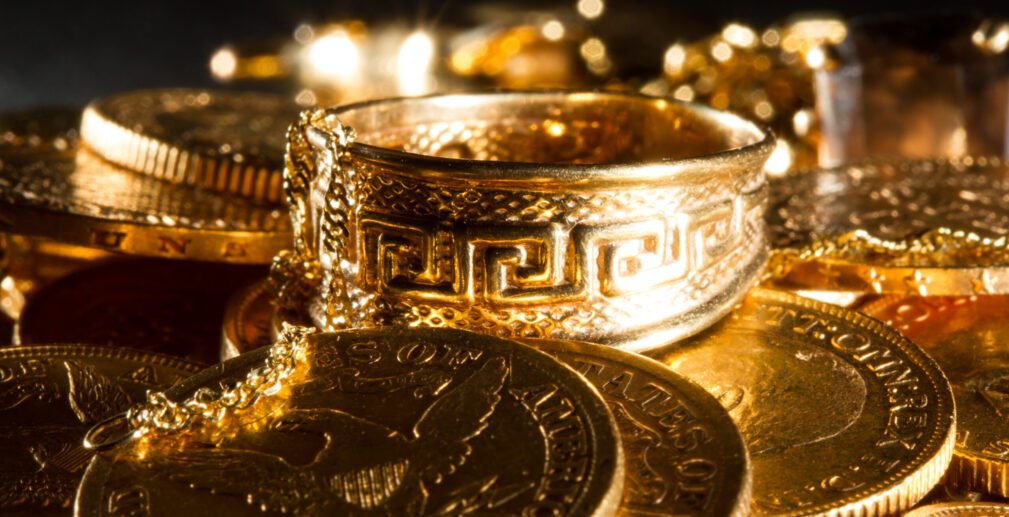 Jewels and gold coins Jewels and gold coins over dark background